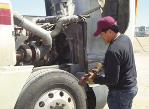 Checking the motor oil in a big rig